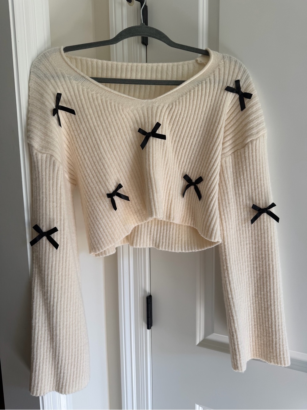 Cream Ribbed Cropped Sweater with Black Bow Accents